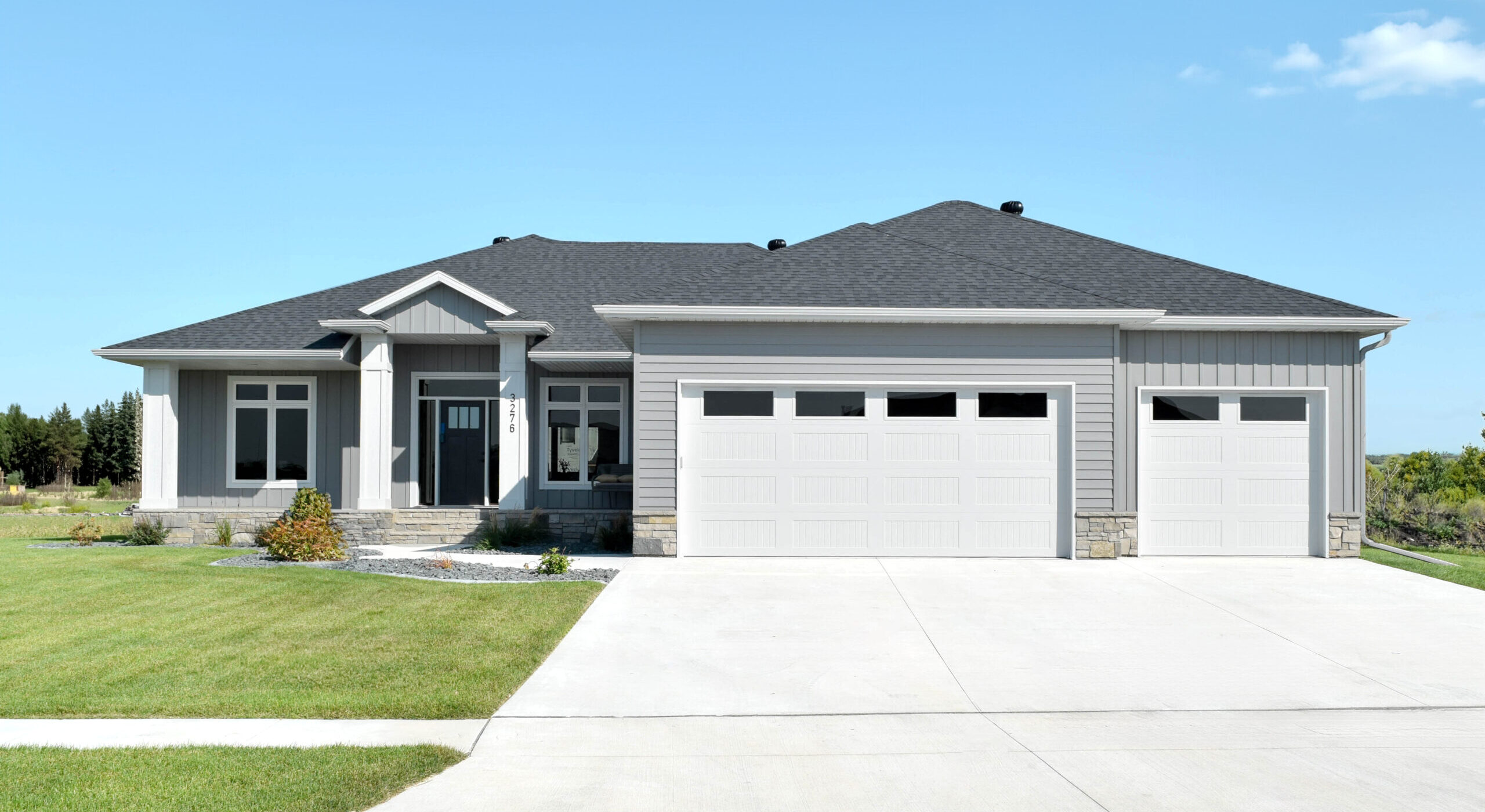 A home with gray seamless siding and white seamless gutters