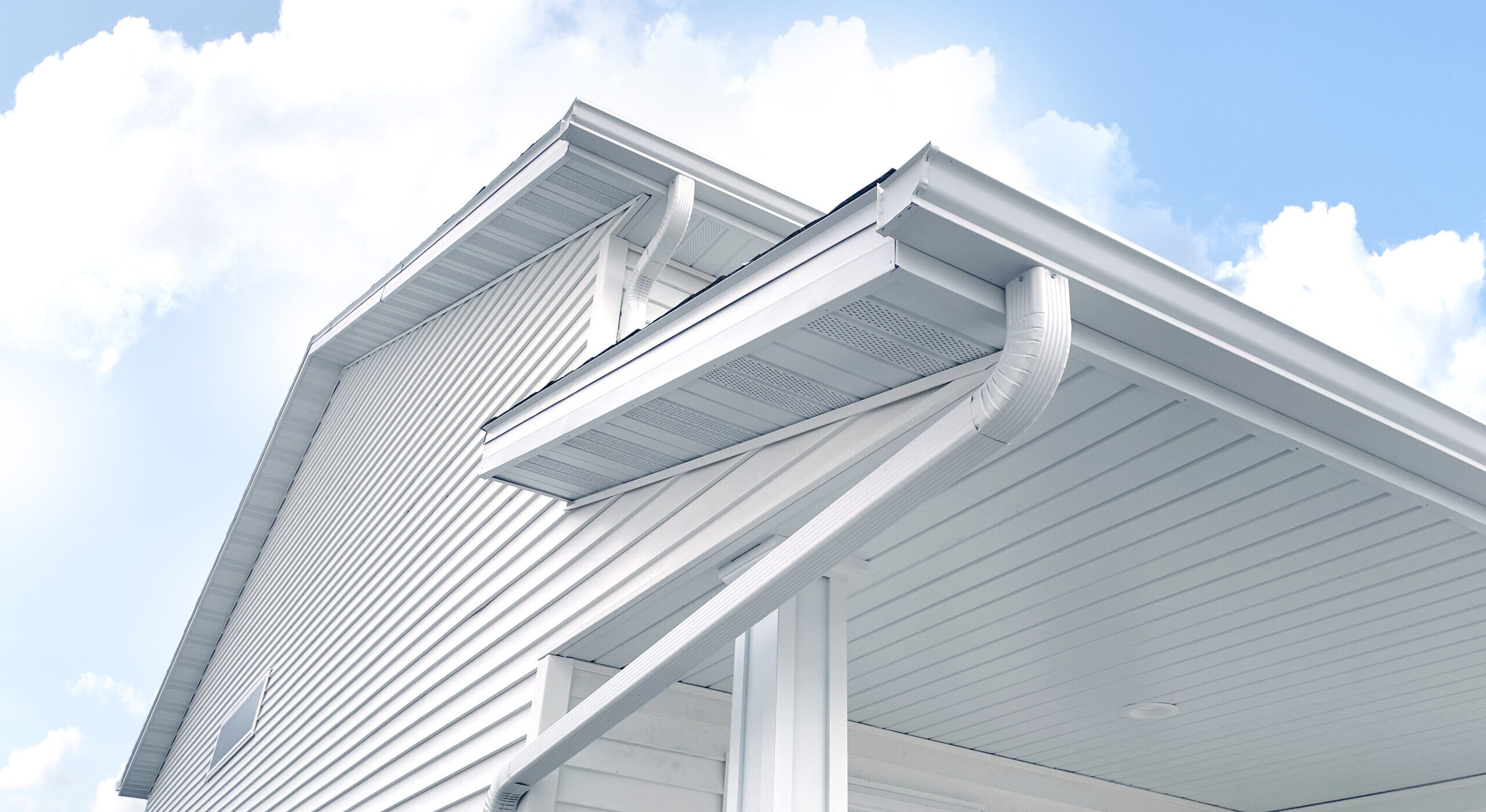 A white house with white gutters